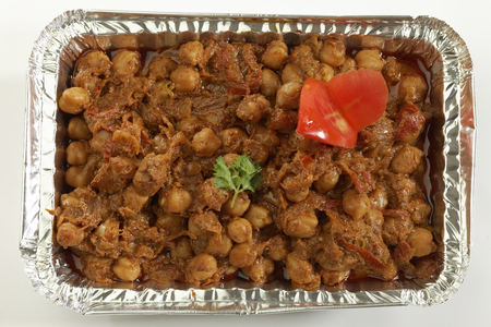 Indian vegetable dish Chana masala in metal foil tray.の写真素材