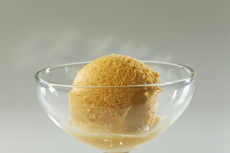 Close up of Scoop of delicious real fresh ice cream in Mango flavour.の写真素材