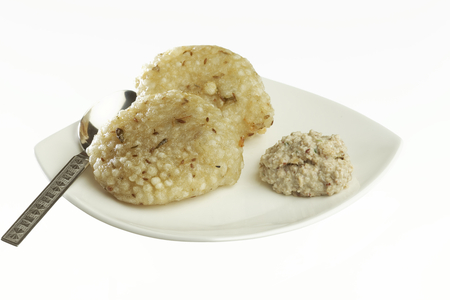 Fast food deep fried sago sabudana vada with chutney on white background.の写真素材