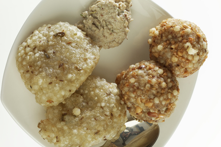 Fast food deep fried sago sabudana vada with chutney on white background.の写真素材