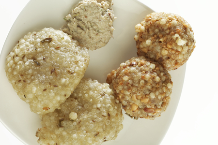 Fast food deep fried sago sabudana vada with chutney on white background.の写真素材
