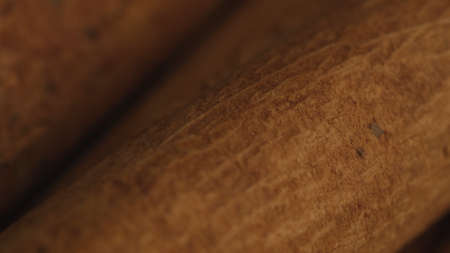 Cinnamon sticks on a dark background. Spicy cinnamon seasoning for baked goods, fruit desserts,...