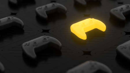 Black joysticks on a black textured surface. Yellow glowing objects on the background. Depth of...