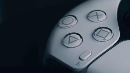 Moscow, Russia - March 12 2021: Wireless white gamepad PlayStation 5 on black background. Spinning...