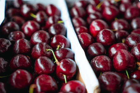 Sweet Cherries on a white wooden box. Fresh juicy red cherry berry rotate. Tasty natural desserts...