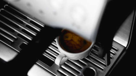 Morning coffee preparation. Coffeemaker. Close-up view of bartender preparing coffee on modern espresso machine. Professional Espresso machine making fresh coffeeの写真素材