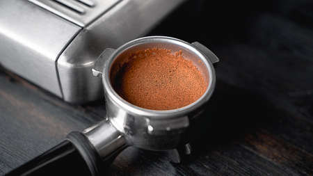 Holder for the coffee machine. Horn espresso coffee maker. Coffee beans. Preparation of espresso....