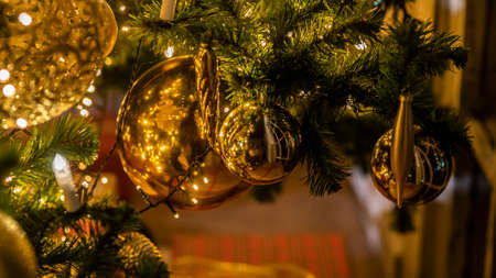 Christmas and New Year interior decoration. Green tree decorated with toys, flashing garland, illuminated lamps. Xmas tree. Cozy christmas atmosphereの写真素材