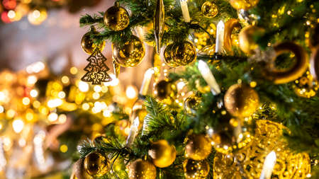 Christmas and New Year interior decoration. Green tree decorated with toys, flashing garland, illuminated lamps. Xmas tree. Cozy christmas atmosphereの写真素材