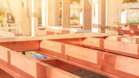 Carcass of wooden beams at cottage construction site on sunny day closeup. Old tradition of building at rural site. organic materials. industrial processの写真素材