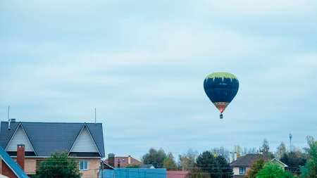 Hot air balloon in the blue cloudy skyの写真素材