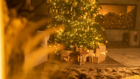 Christmas holiday decor with tree deer fireplace and fairy lights at home. Festive garlands illuminated living room prepared for Xmas celebration. Cozy winter season and domestic lifeの写真素材