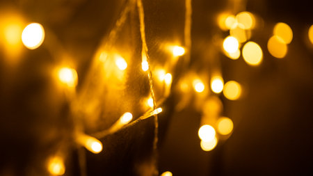 Fairy lights mesh on decorative deer in Christmas interior design closeup. Garland of glowing lamps on toy animal as Xmas holiday symbol. Comfortable festive atmosphere ornament at homeの写真素材