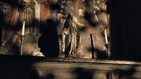 Antique old statue on the background of a stone fresco wall. Impressive Gothic sculpture in the church. Close-up, depth of fieldの写真素材