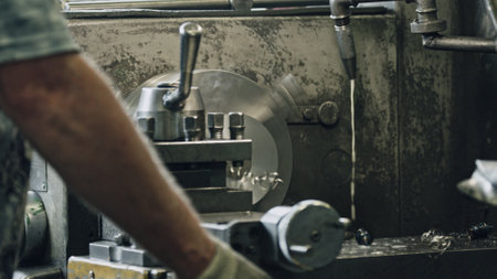 Close up of metal processing on lathe machine with coolant, metalworker operating lathe, shaping metal detail, industrial manufacturing processの写真素材