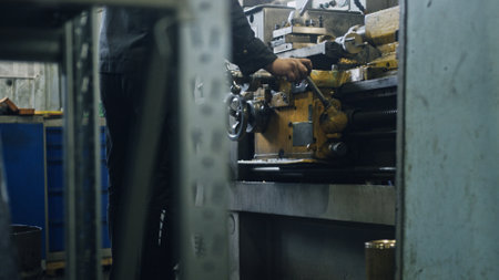 Industrial worker operating a lathe machine, skillfully shaping metal in a factory workshop, emphasizing precision and the intricate manufacturing processes involved in metalworkingの写真素材