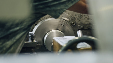 Close up of lathe machine shaping metal detail, industrial manufacturing process, metal worker operating machinery in factory, engineering and metalworking conceptの写真素材