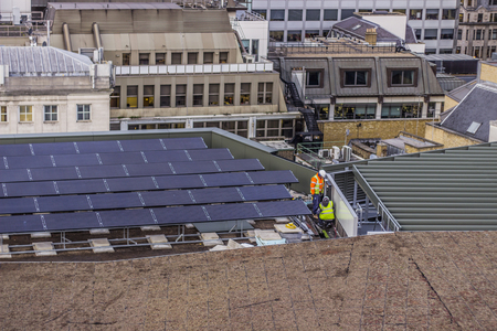 Workers installing solar panels in Londonのeditorial素材
