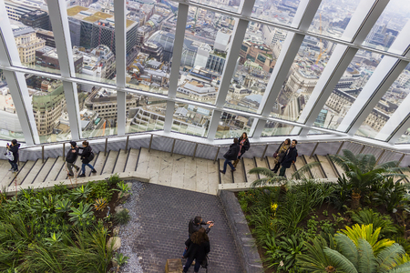 Visitors walking around in the Sky Garden glass house at the top of the Fenchurch building in London, England.のeditorial素材