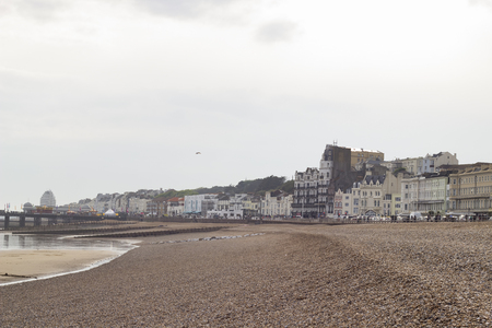 A view from the pebble beach over the city and pier of Hastings, England.の写真素材