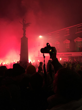 Lewes, England - 5 November 2016: Dark and crowded streets of Lewes are covered in smoke due to the explosions and fire parade of the yearly celebration of the Bonfire night festivities.のeditorial素材