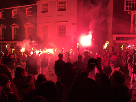 Lewes, England - 5 November 2016: Dark and crowded streets of Lewes are covered in smoke due to the...