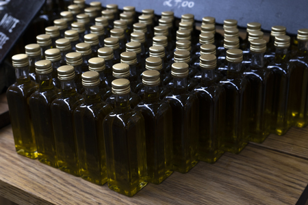 Close up of a display of olive oil bottles on a street market.の写真素材