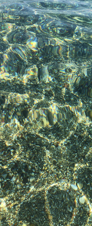 A panorama looking through tropical sea with reflections from the water and the sun light, to be...