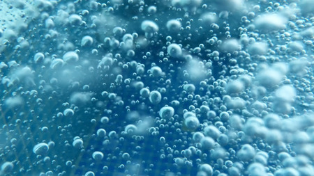 Close up shot of air bubbles taken underwater symbolising the essence of life and the universe. A great background to use for science and technology themes.の写真素材