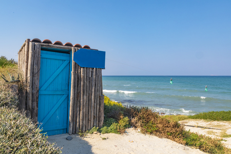 View of a small wooden cabin on the shore of the azure Mediterranean Sea, with a sign that can be used as a placeholder for your own personalised message.の写真素材