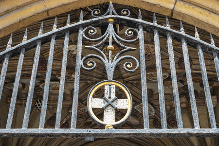 Canterbury, England - June 24, 2018: Close up view of the entrance gate and coats of arms of the...