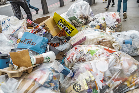 London, United Kingdom - March 23, 2019: Rubbish bags piled up on the streets of London in front of the parliament with an Anti Brexit sign saying âwe demand a people voteâ.のeditorial素材