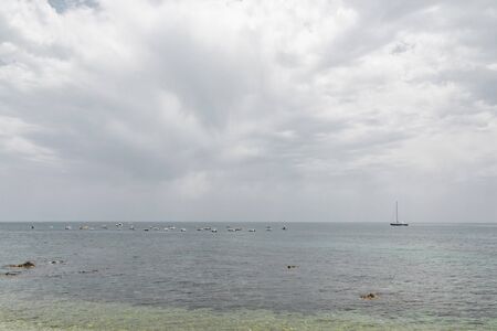 Sailing boat and yachts on tropical sea
