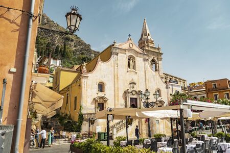 Taormina Sicily, Italy - July 9 2019: view of the iconic landmark church of Saint Joseph in front of the IX April Square with tourists and restaurantsのeditorial素材