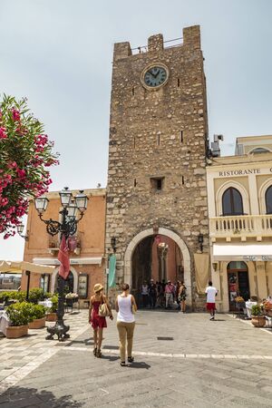 Taormina Sicily, Italy - July 9 2019: Street view of the clock tower on the Corso Umberto in the old townのeditorial素材