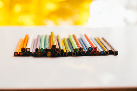 colored pencils in a container on a white background.の写真素材