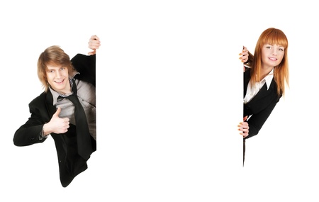 Portrait of a successful young business man and business woman holding an empty billboard against white backgroundの写真素材
