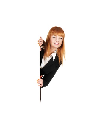 Attractive business woman stands next to a blank presentation boardの写真素材