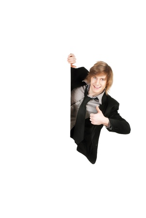 Portrait of a successful young business man holding an empty billboard against white backgroundの写真素材