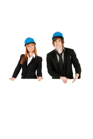 Business man and business woman holding board with helmets onの写真素材