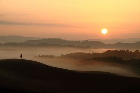 sunrise with tuscan hills and morning fog, Italy, Europeの写真素材