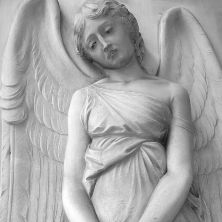 sad cemetery angel relief on monumental italian churchyard,Staglieno Genoa, Italy, Europe