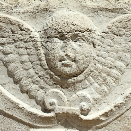 antique angel relief - detail of decoration on antique well in Venice, Italy, Europeの写真素材