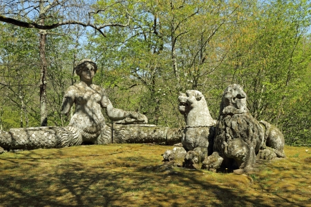 The bench like siren and two lions sculptures in Park of the Monsters (Parco dei Mostri ), also named Sacred Grove ( Sacro Bosco ), Bomarzo , Italy, Europeの写真素材