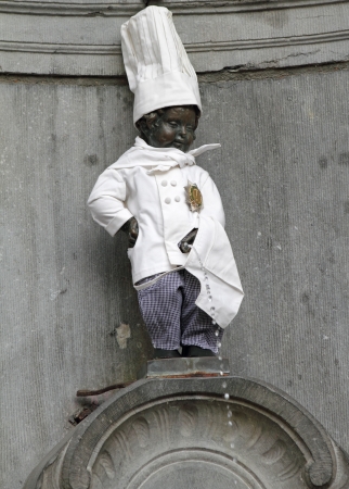 BRUSSELS - APRIL 30  Manneken Pis - famous Brussels landmark on April 30, 2013  Statue is often dressed in costume according to a schedule  His wardrobe consists of several hundred different costumes のeditorial素材