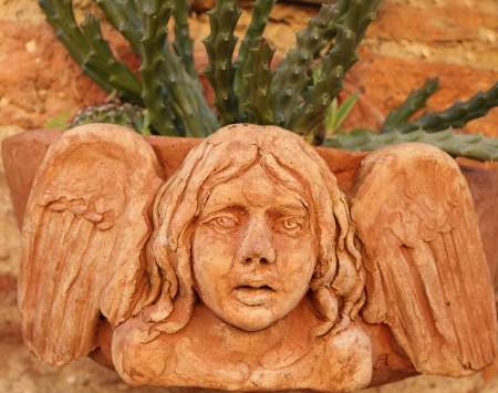 ceramic planter decorated with angelic relief