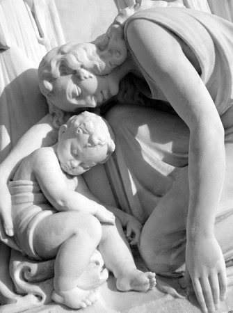 mother mourning her child - sculpture on monumental cemeteryの写真素材