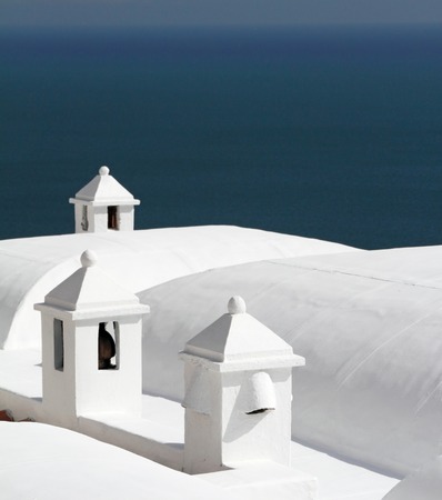 chimneys on white painted roofs of houses in Positano on Amalfi Coast, Italyの写真素材