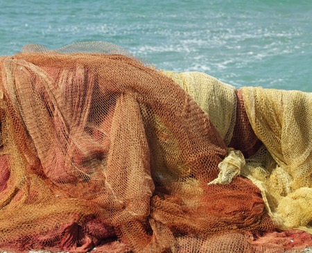 colorful fishing nets in sun on sea coast, Italy の写真素材
