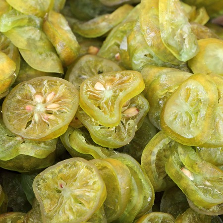 many sliced candied lemon fruits as backgroundの写真素材